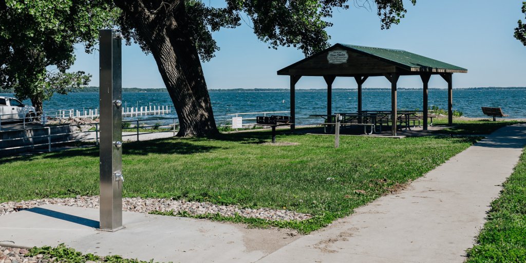 A picnic area with a tree and a bench in Orleans, Iowa