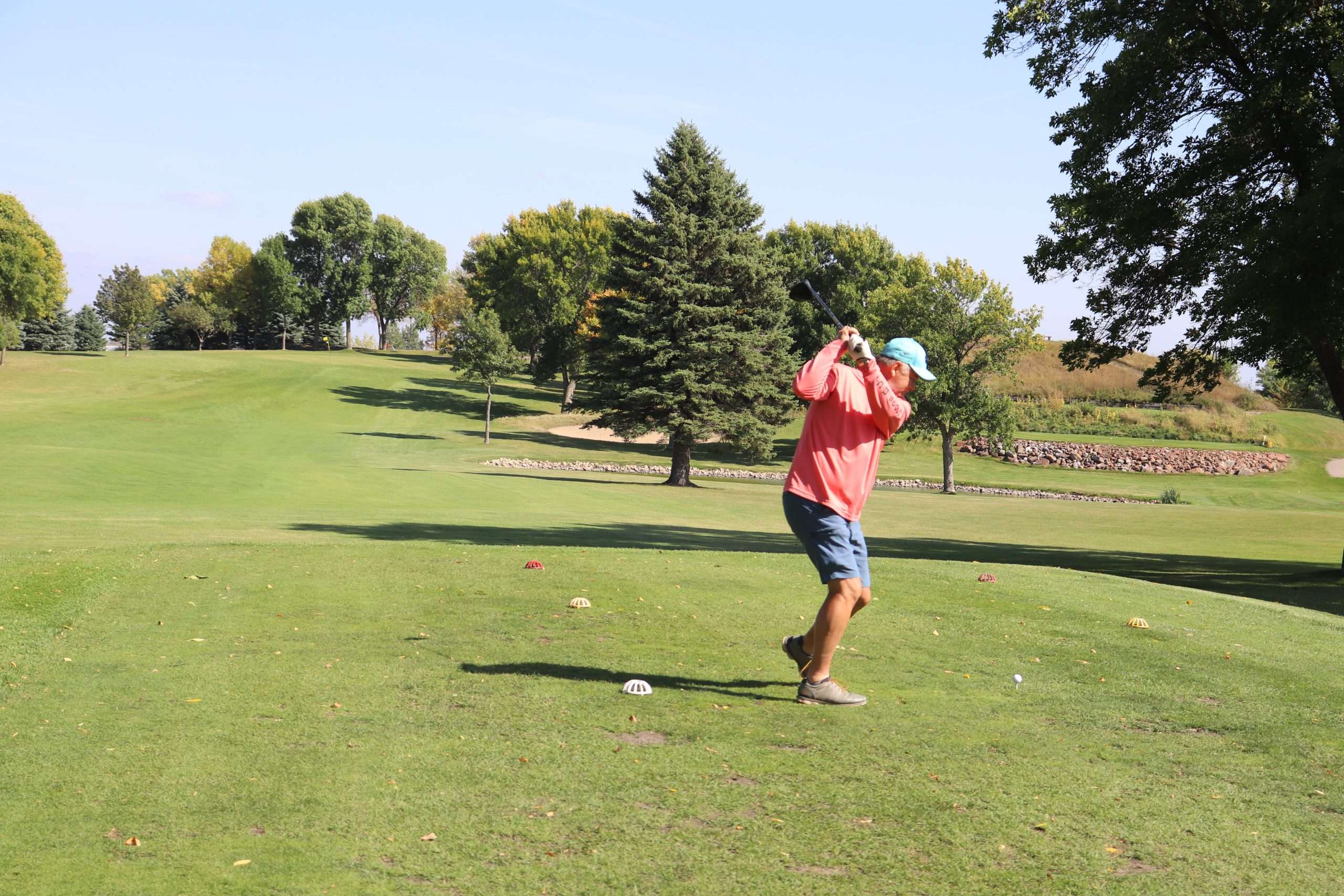 24.indian.hills_golf Man taking a swing at a golf ball at Indian Hills Golf Club in Spirit Lake, Iowa