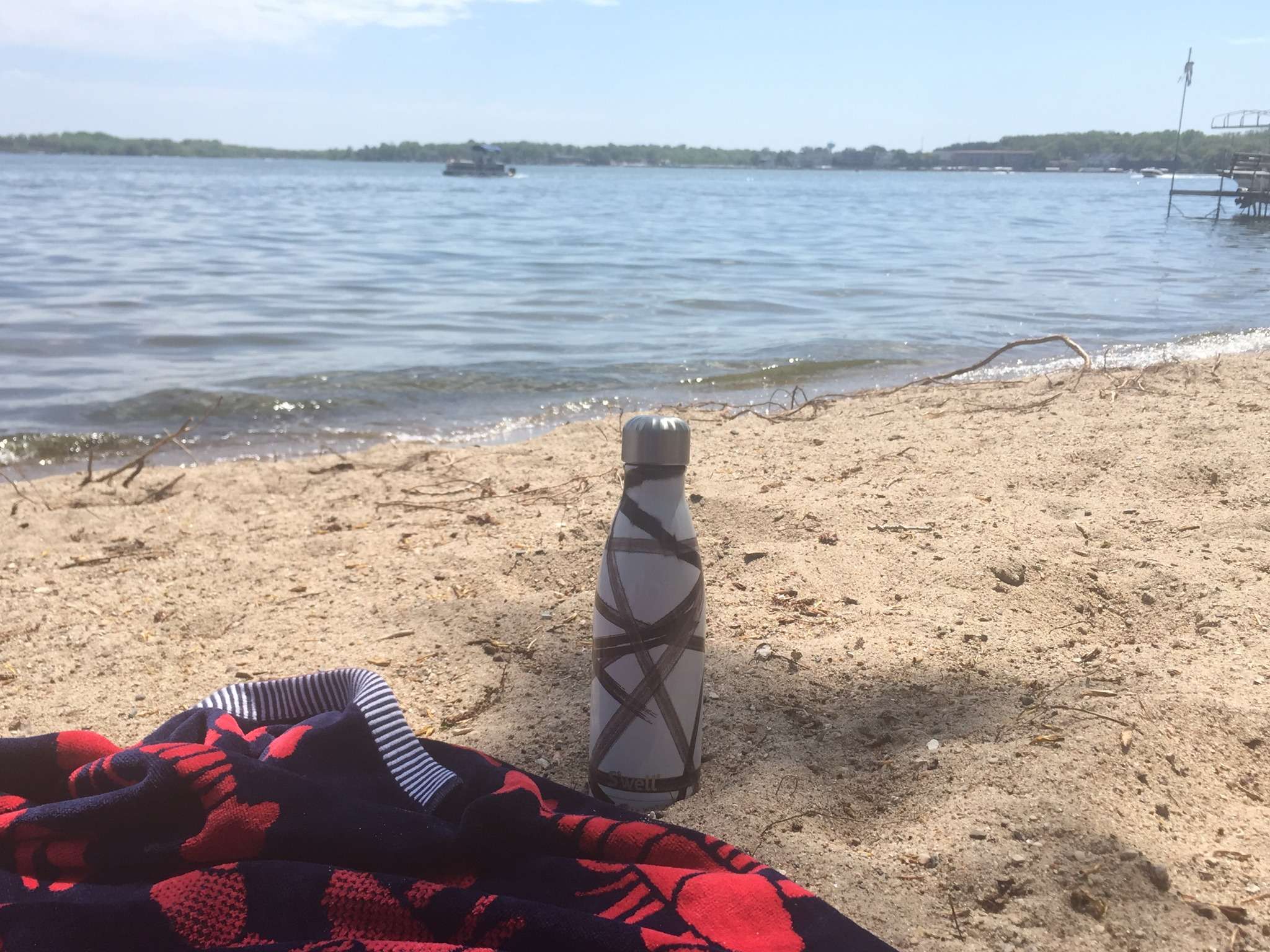 423327713_785723466918262_6615939856970009409_n beach time at Lake Okoboji with towel down and bottle of water to enjoy