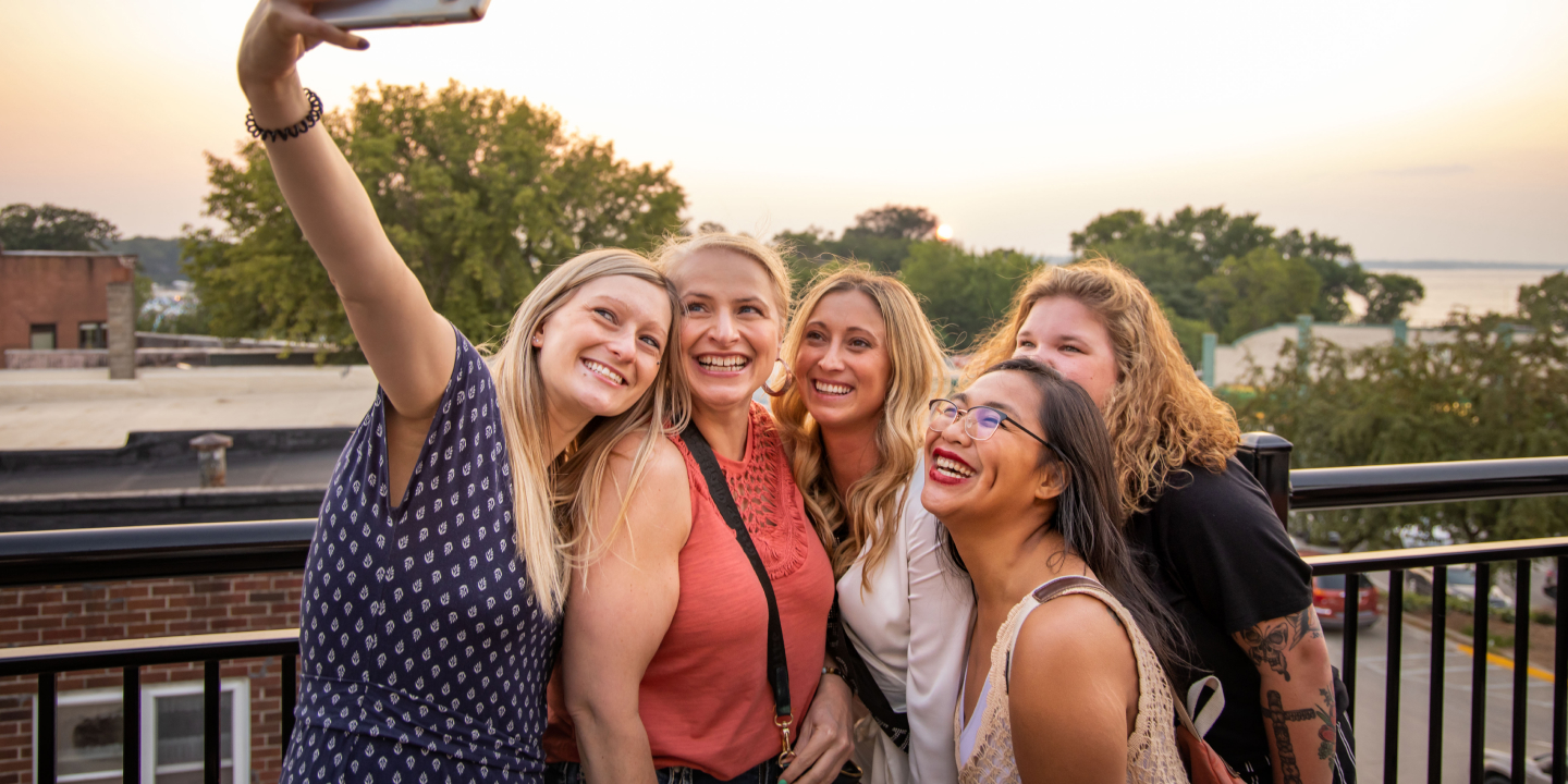 City of Terril 3 A group of women taking a selfie on a rooftop patio